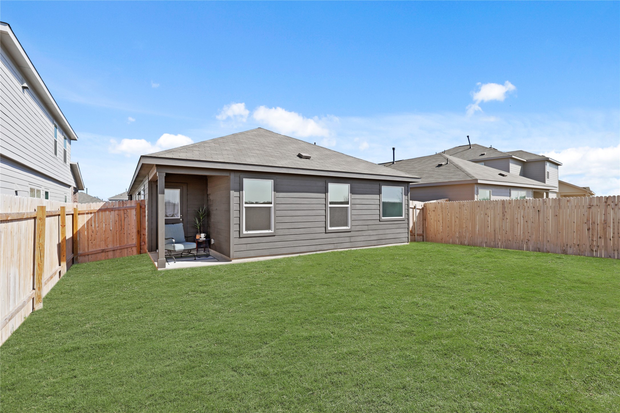 1073 Soapstone Pass Maxwell, TX 78656 - Photo 24 of 28 a view of a house with backyard and porch