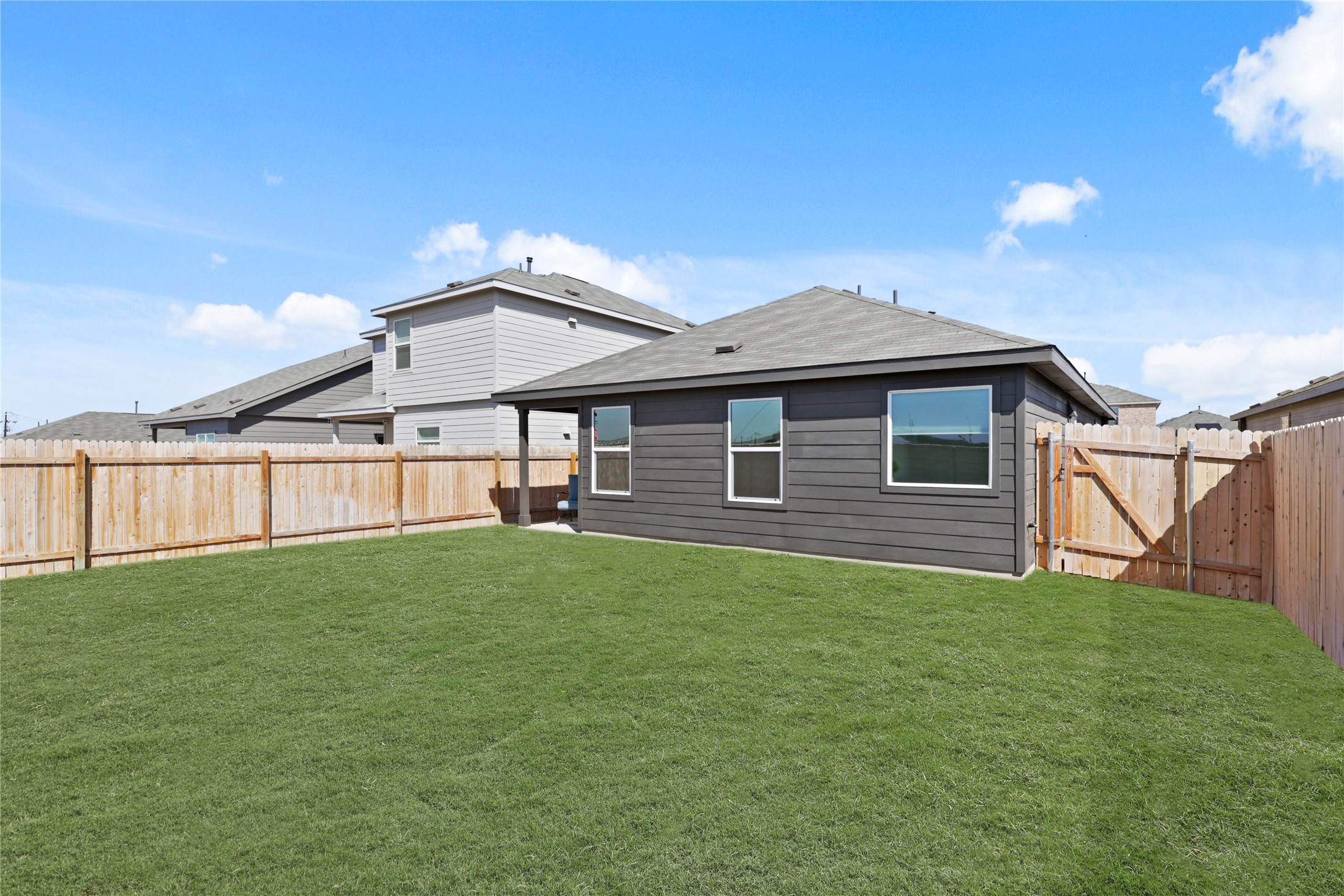 1073 Soapstone Pass Maxwell, TX 78656 - Photo 26 of 28 a backyard of a house with table and chairs