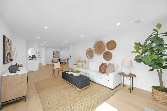 a living room with furniture a fireplace and a potted plant