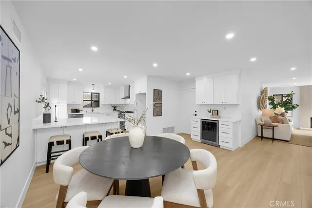 a open dining room with furniture a fireplace and kitchen view