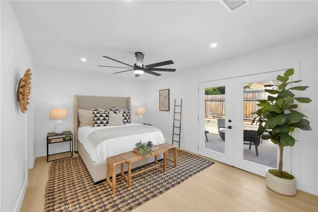 a living room with a bed furniture and a large window