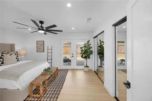 a bedroom with a bed and ceiling fan