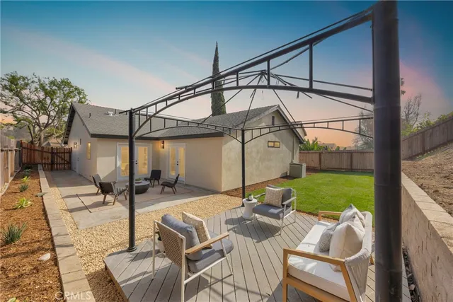 a view of an house with backyard space and balcony