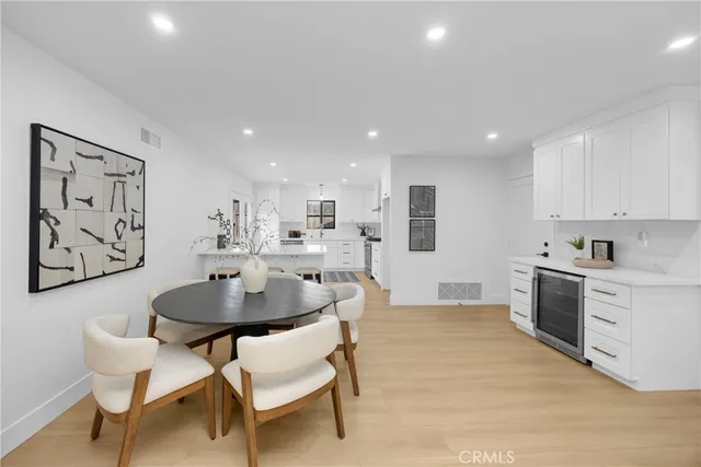 a kitchen with stainless steel appliances kitchen island granite countertop a sink and a refrigerator