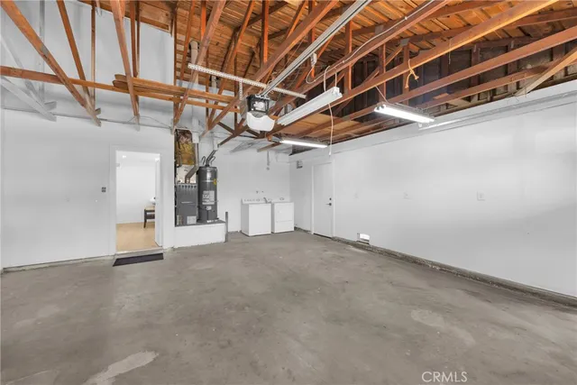 a view of a big room with wooden floor and a ceiling fan