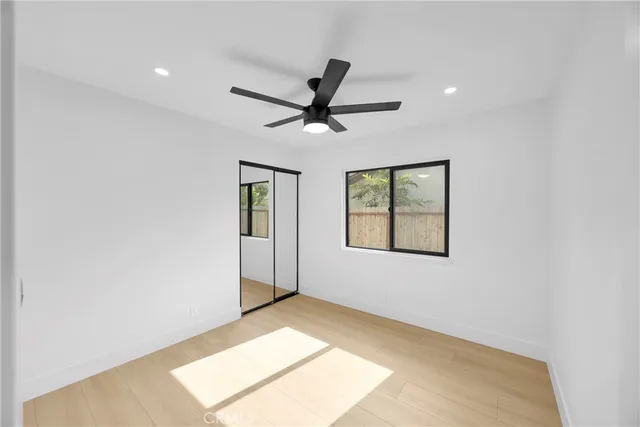 a view of a livingroom with a ceiling fan and window