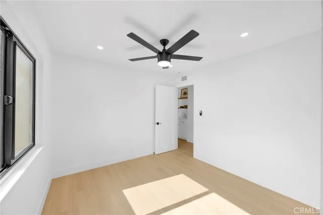 a view of a livingroom with a ceiling fan and window