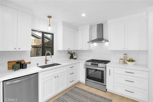 a large kitchen with stainless steel appliances and cabinets