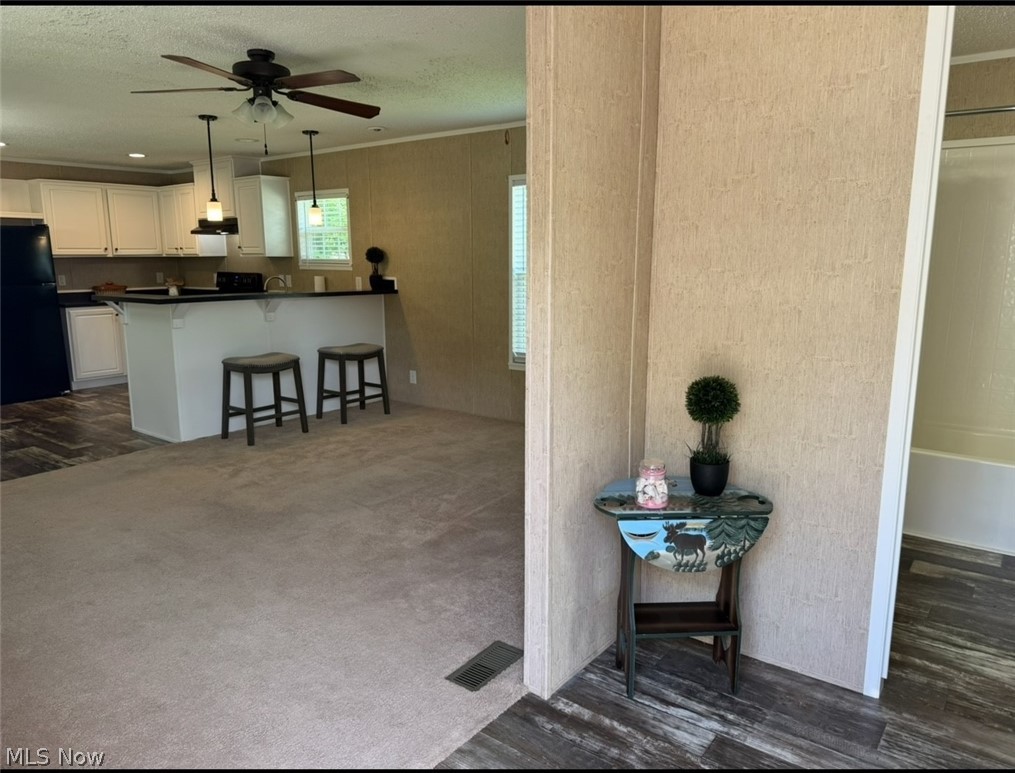 202 West Main Road, Unit 139 Conneaut, OH 44030 - Photo 38 of 45 Open-concept living space with beige carpeting and wood-finish flooring
