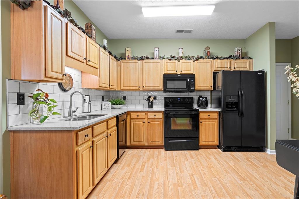 3731 Villa Springs Circle Powder Springs, GA 30127 - Photo 12 of 34 a kitchen with stainless steel appliances a refrigerator and a sink