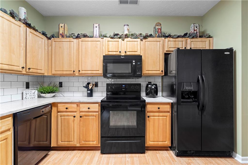 3731 Villa Springs Circle Powder Springs, GA 30127 - Photo 15 of 34 a kitchen with stainless steel appliances granite countertop a refrigerator stove and sink