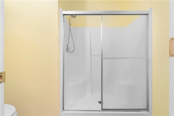 a bathroom with a glass shower door