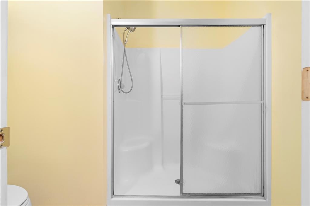 3731 Villa Springs Circle Powder Springs, GA 30127 - Photo 23 of 34 a bathroom with a glass shower door