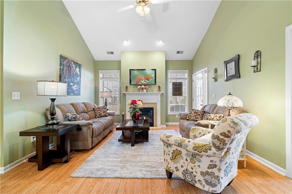 3731 Villa Springs Circle Powder Springs, GA 30127 - Photo 7 of 34 a living room with furniture fireplace and a chandelier