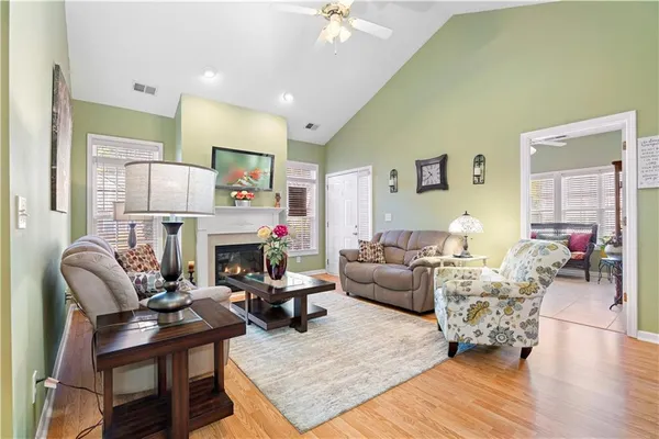 a living room with fireplace furniture and a wooden floor