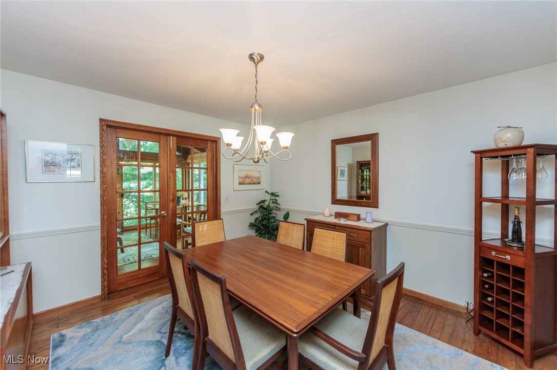 37451 Hunters Ridge Solon, OH 44139 - Photo 6 of 42 Dining room featuring wood finished floors, french doors, and a chandelier