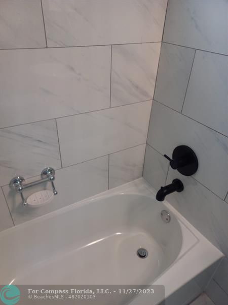 1861 Northeast 161st Street North Miami Beach, FL 33162 - Photo 12 of 32 a bathroom with a tub