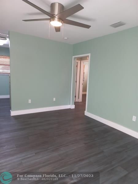 1861 Northeast 161st Street North Miami Beach, FL 33162 - Photo 17 of 32 a view of an empty room with wooden floor