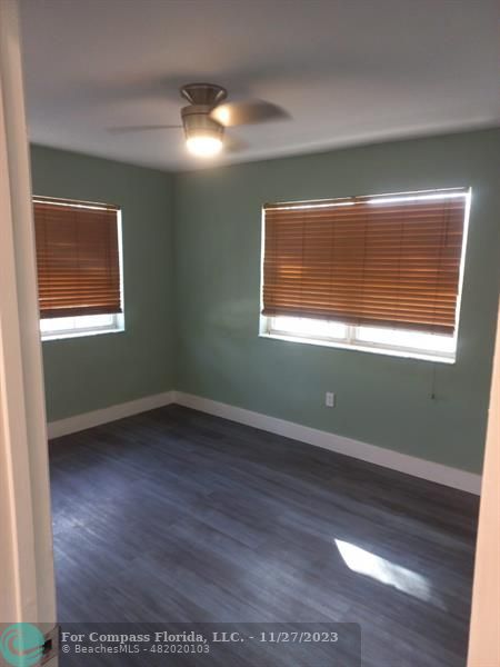 1861 Northeast 161st Street North Miami Beach, FL 33162 - Photo 18 of 32 a view of an empty room with wooden floor and a window