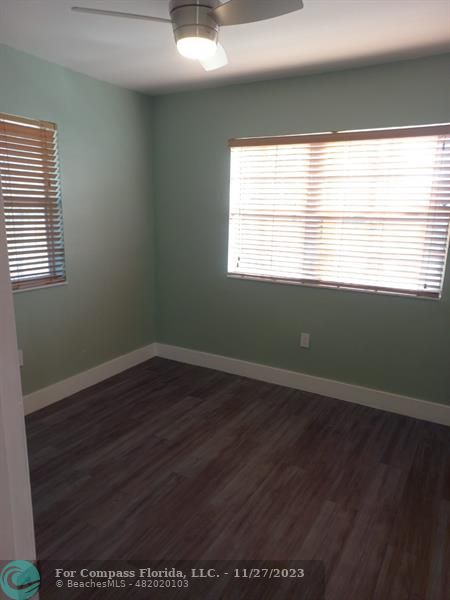 1861 Northeast 161st Street North Miami Beach, FL 33162 - Photo 19 of 32 a view of an empty room with wooden floor and a window