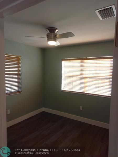 1861 Northeast 161st Street North Miami Beach, FL 33162 - Photo 20 of 32 a view of an empty room with wooden floor and a window