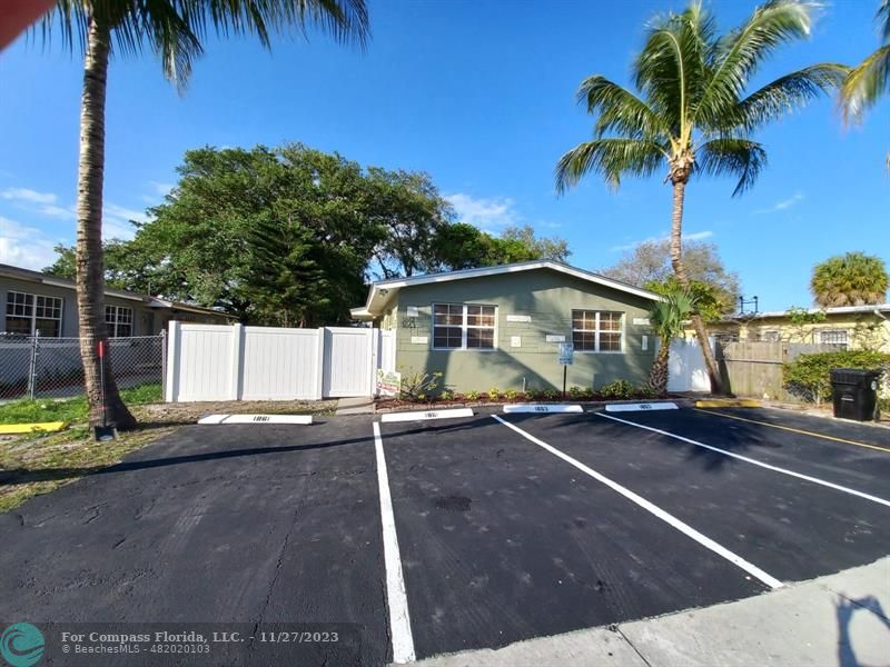 1861 Northeast 161st Street North Miami Beach, FL 33162 - Photo 2 of 32 a front view of a house with a yard and garage