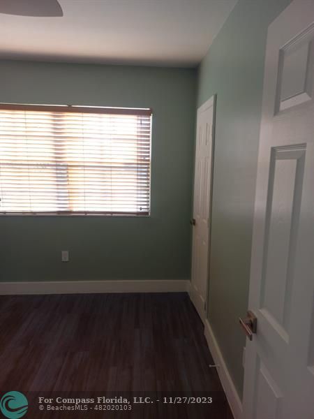 1861 Northeast 161st Street North Miami Beach, FL 33162 - Photo 22 of 32 a view of an empty room with wooden floor and a window