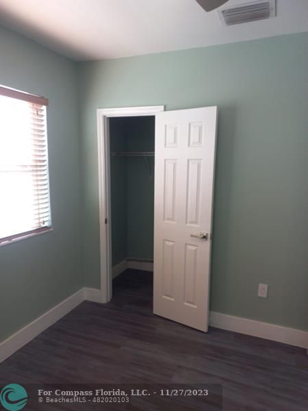 1861 Northeast 161st Street North Miami Beach, FL 33162 - Photo 23 of 32 an empty room with wooden floor and closet