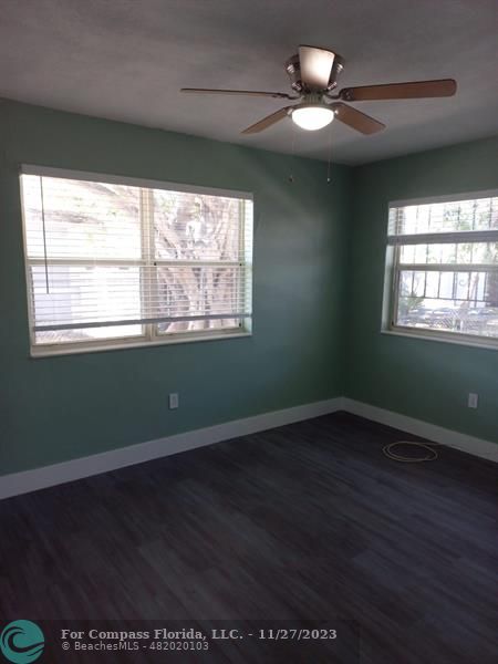 1861 Northeast 161st Street North Miami Beach, FL 33162 - Photo 6 of 32 a view of an empty room with wooden floor and a window