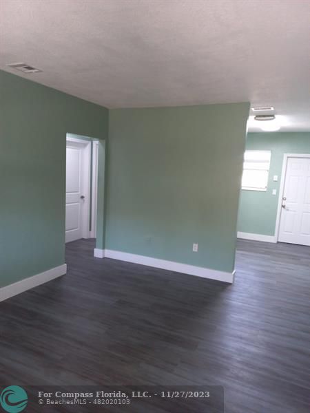 1861 Northeast 161st Street North Miami Beach, FL 33162 - Photo 7 of 32 a view of a room with wooden floor and window