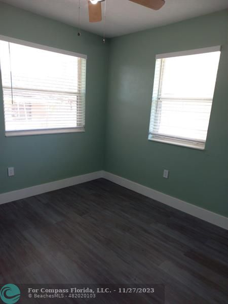 1861 Northeast 161st Street North Miami Beach, FL 33162 - Photo 8 of 32 an empty room with wooden floor and windows