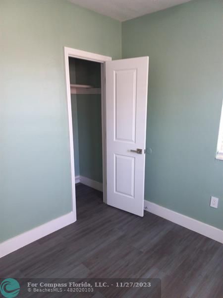 1861 Northeast 161st Street North Miami Beach, FL 33162 - Photo 9 of 32 an empty room with wooden floor