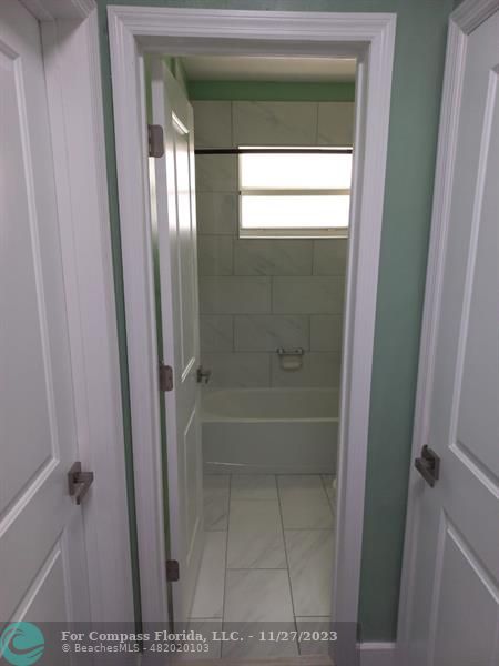 1861 Northeast 161st Street North Miami Beach, FL 33162 - Photo 10 of 32 a bathroom with a glass shower door