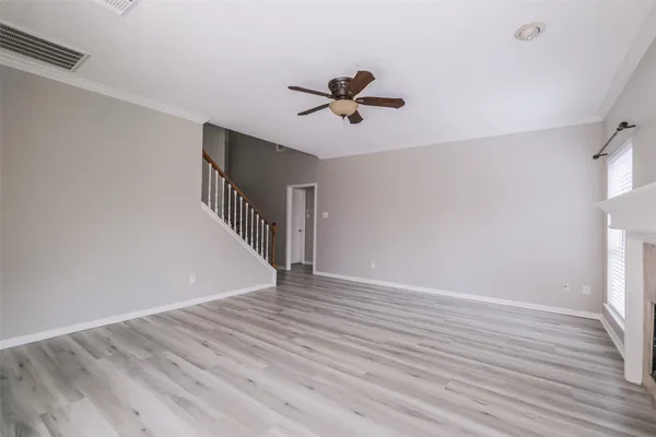 a large white kitchen with a refrigerator a stove a sink and a window