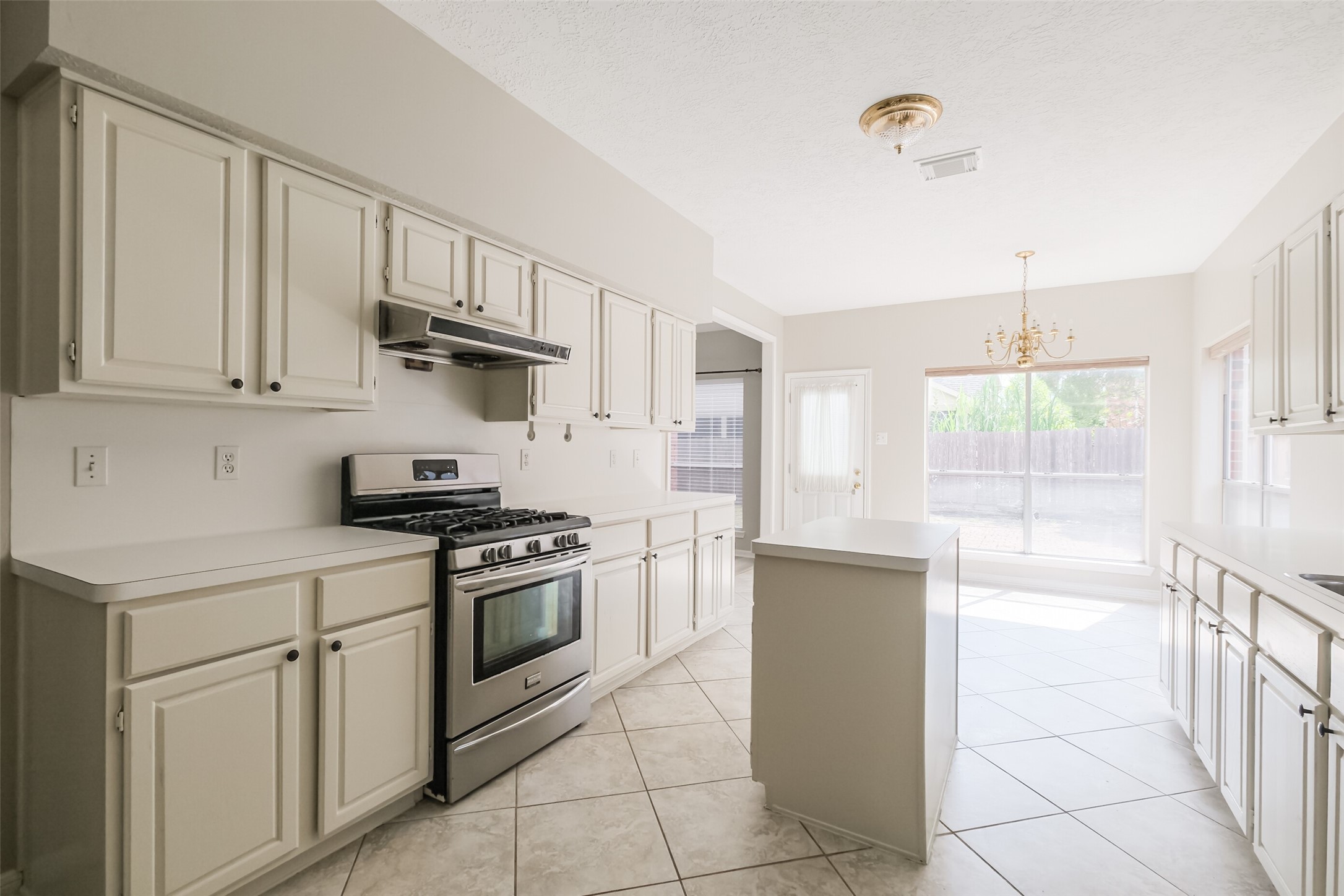7603 Quintero Drive Houston, TX 77083 - Photo 16 of 36 a kitchen with stainless steel appliances granite countertop a stove a sink and a refrigerator