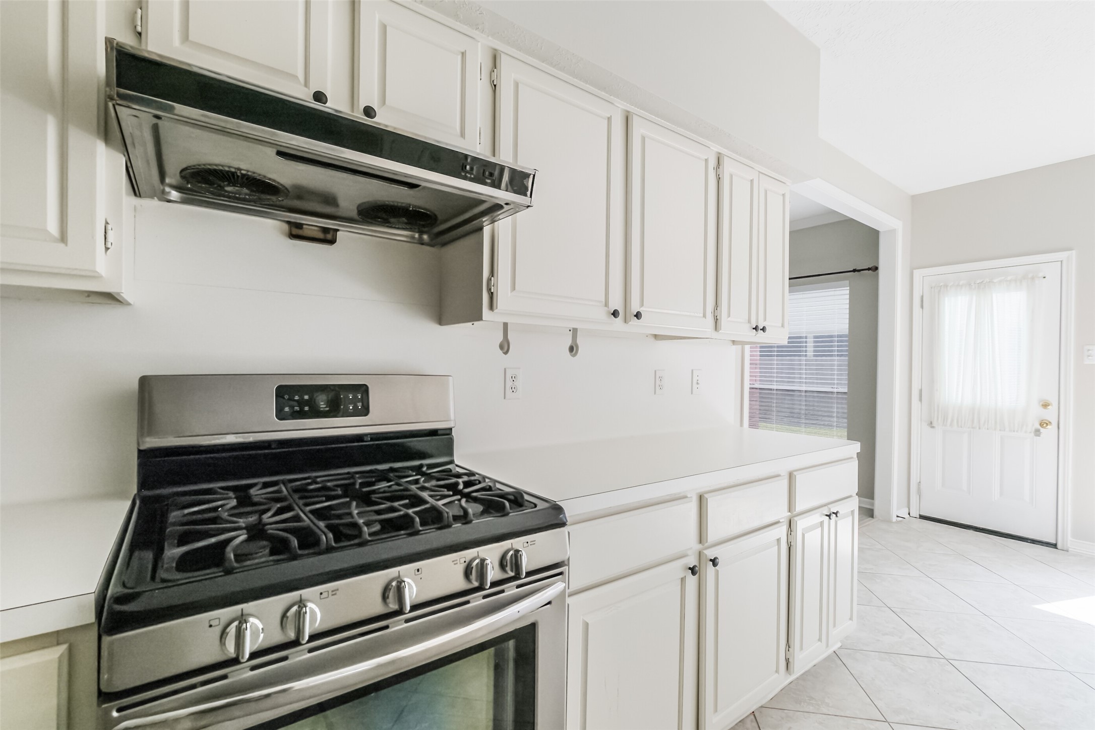 7603 Quintero Drive Houston, TX 77083 - Photo 18 of 36 a kitchen with white cabinets and appliances
