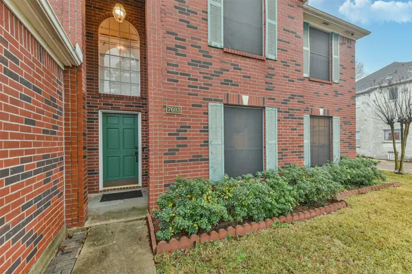 a view of a brick house with a yard
