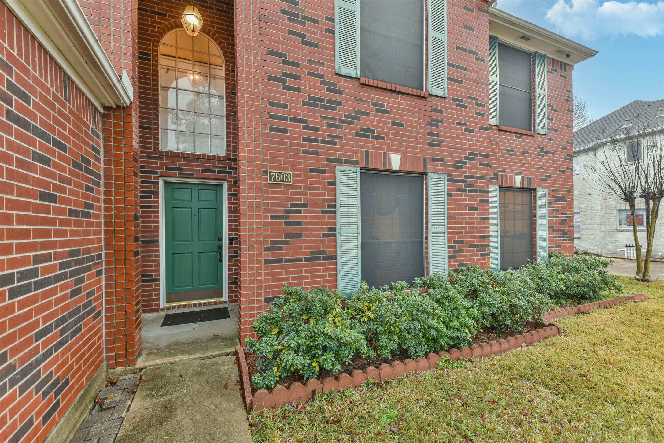 7603 Quintero Drive Houston, TX 77083 - Photo 2 of 36 a view of a brick house with a yard