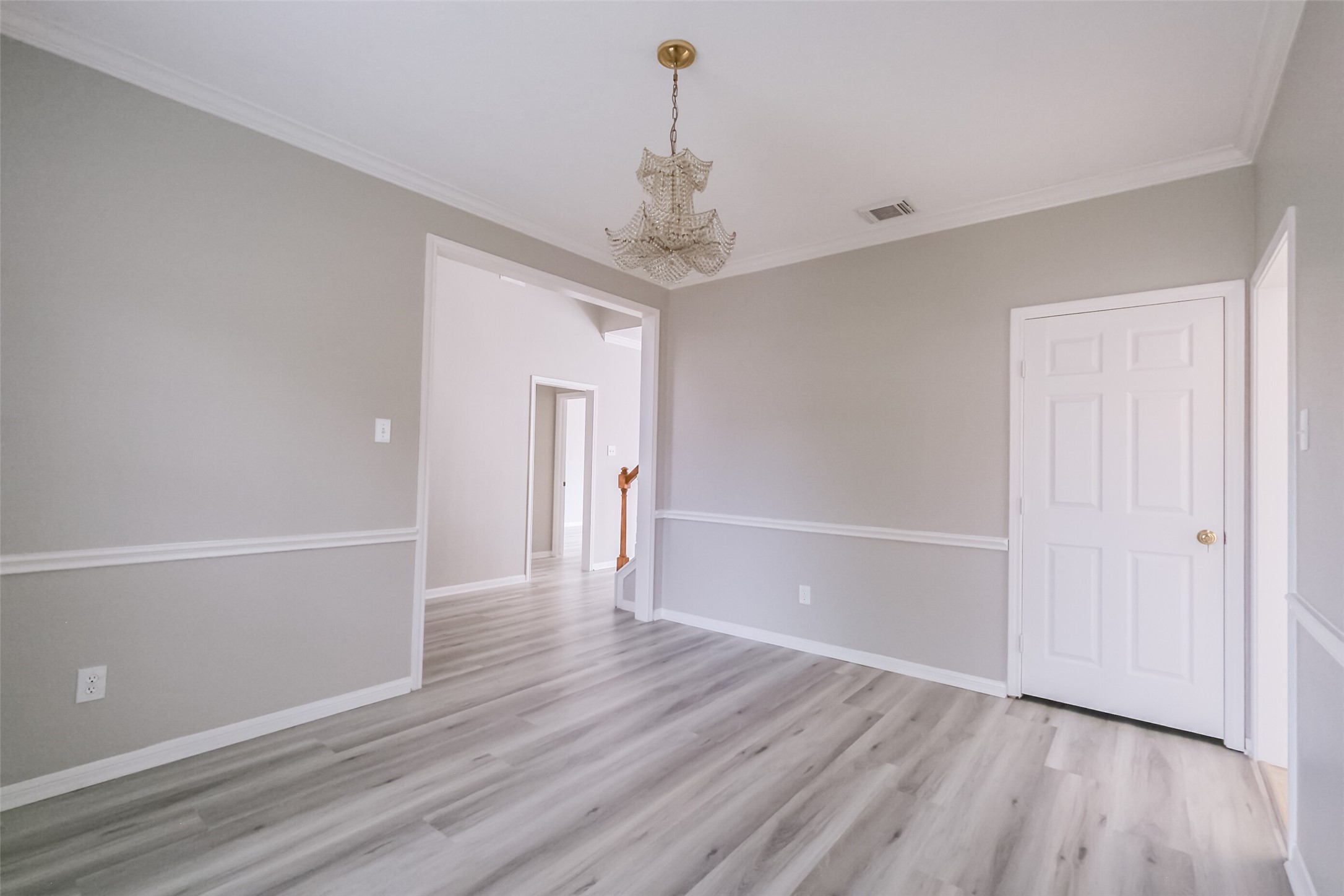 7603 Quintero Drive Houston, TX 77083 - Photo 23 of 36 a view of a hallway with wooden floor and chandelier