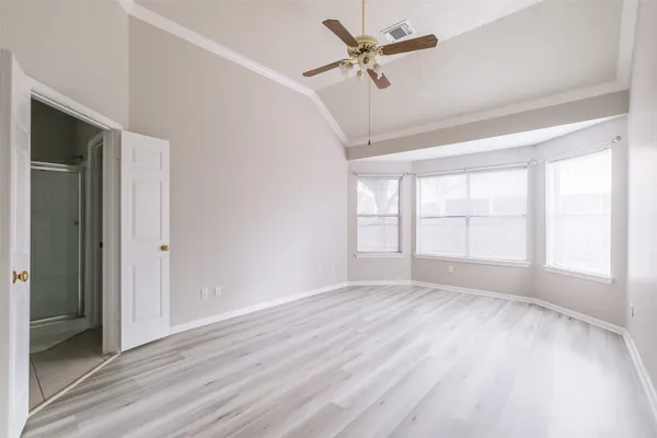 a view of an empty room and wooden floor