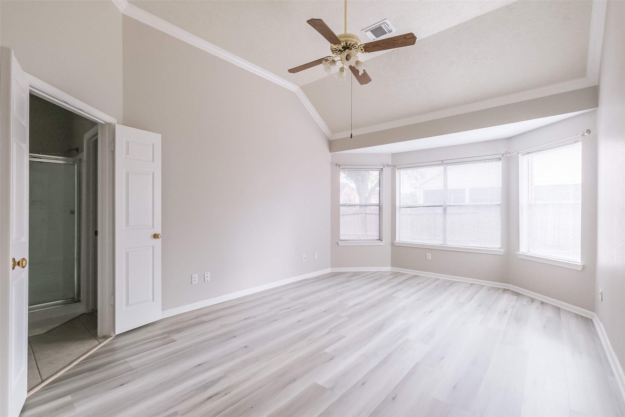 7603 Quintero Drive Houston, TX 77083 - Photo 24 of 36 an empty room with wooden floor fan and windows