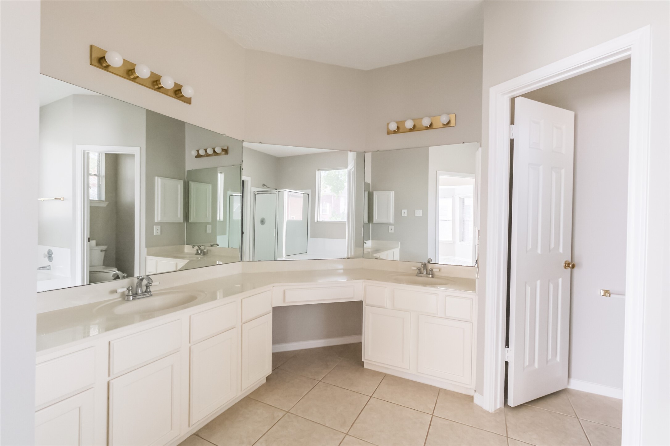 7603 Quintero Drive Houston, TX 77083 - Photo 26 of 36 a large white bathroom with a double vanity sink a mirror and a bathtub