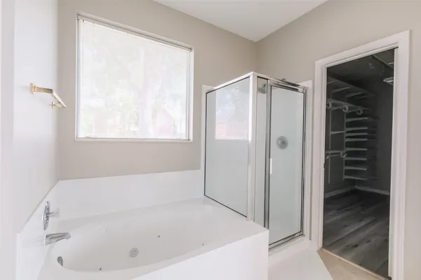 a view of walk in closet with empty racks