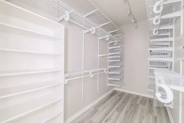 a view of walk in closet with empty racks