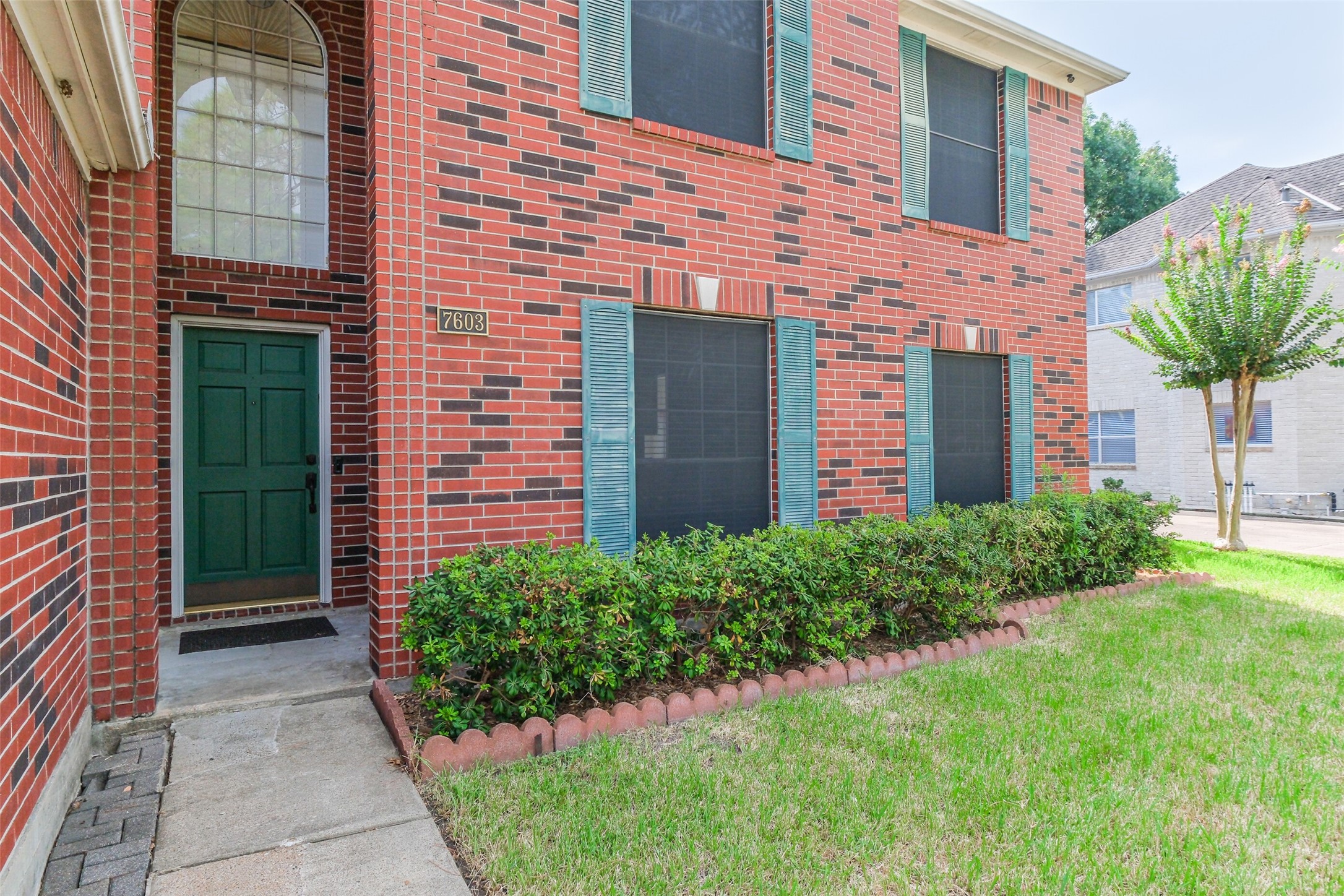 7603 Quintero Drive Houston, TX 77083 - Photo 3 of 36 a front view of a house with garden