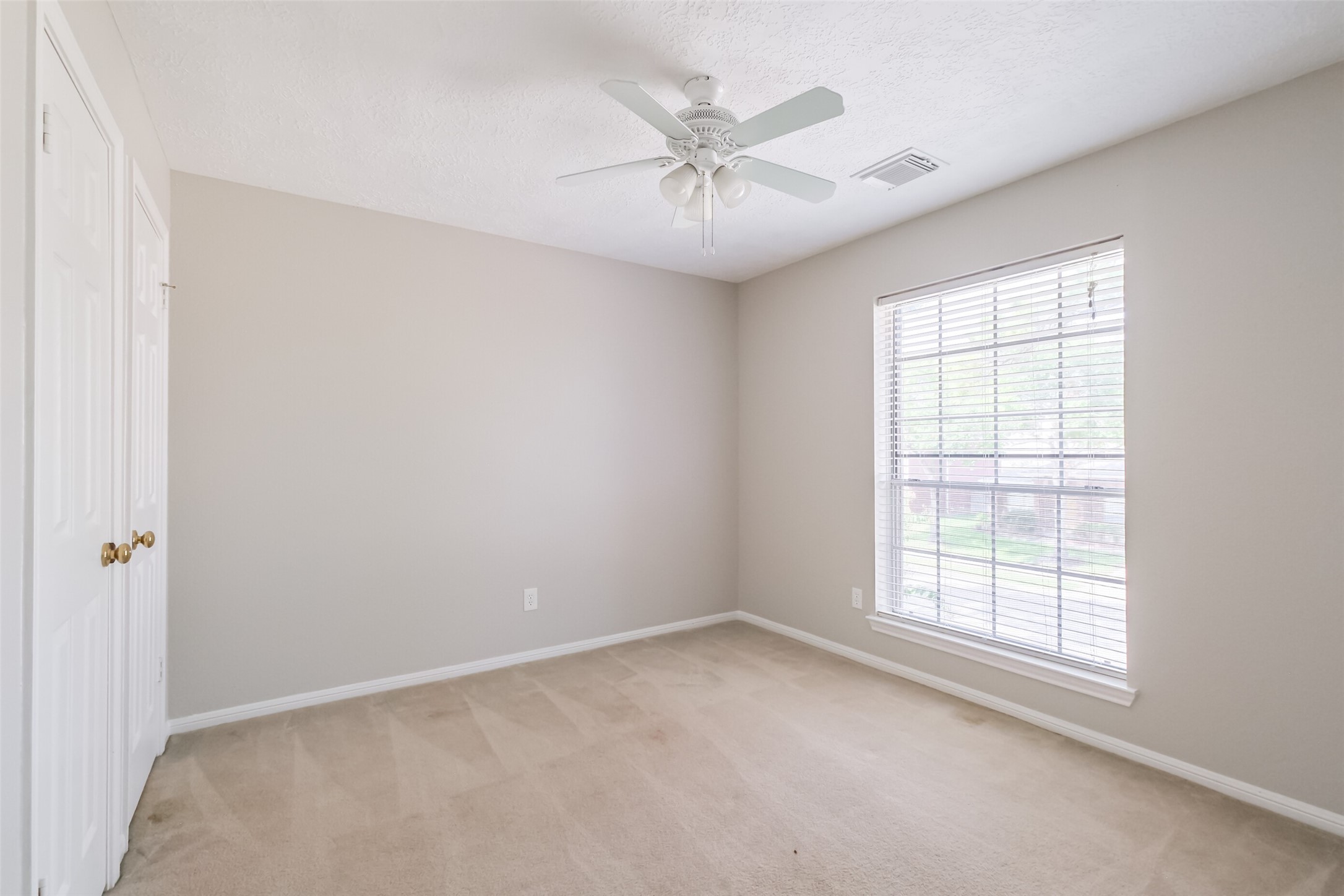 7603 Quintero Drive Houston, TX 77083 - Photo 35 of 36 an empty room with a window and a fan