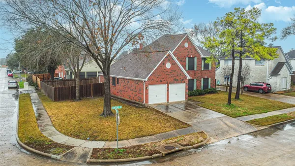 a view of a house with a yard and fence