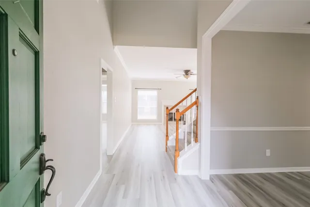 a view of an empty room with a window and fireplace