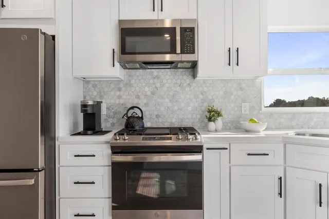 a kitchen with cabinets stainless steel appliances and a sink