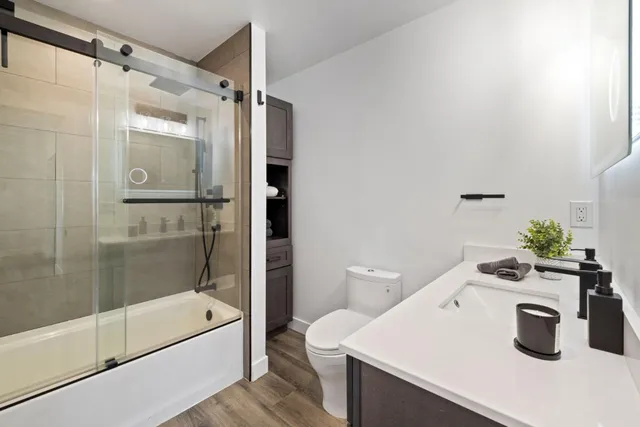 a bathroom with a sink a mirror and a shower
